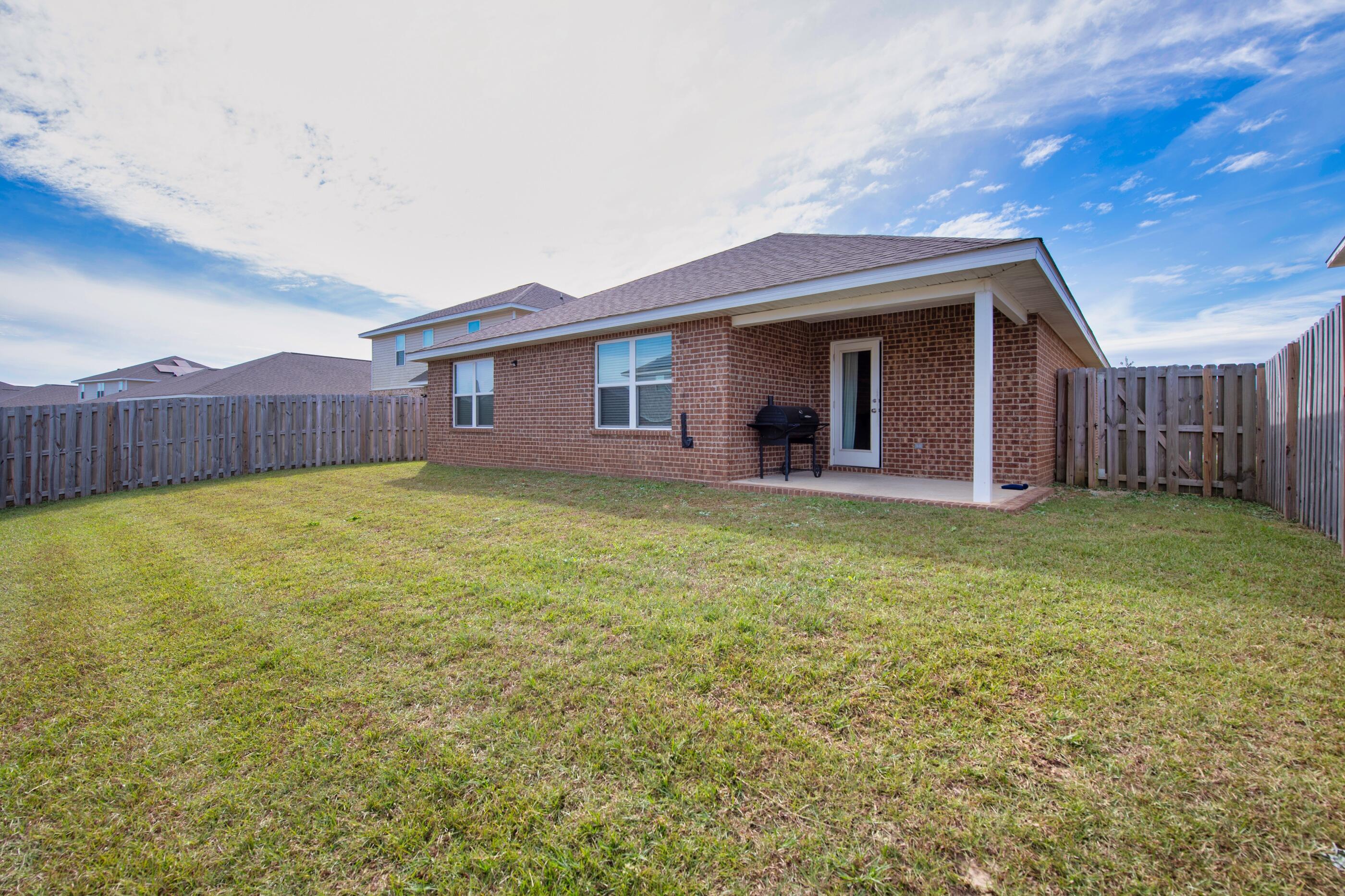 812 Moorhen Way Crestview, FL 32539 - Photo 21 of 22 a view of a house with a yard and porch