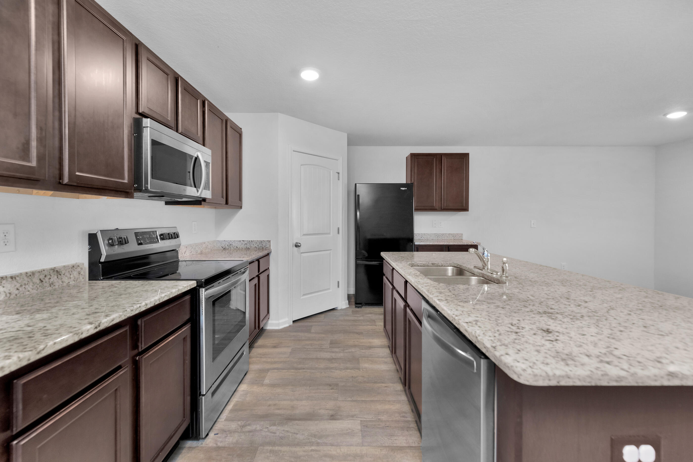 812 Moorhen Way Crestview, FL 32539 - Photo 3 of 22 a kitchen with stainless steel appliances granite countertop a kitchen island a stove and a sink