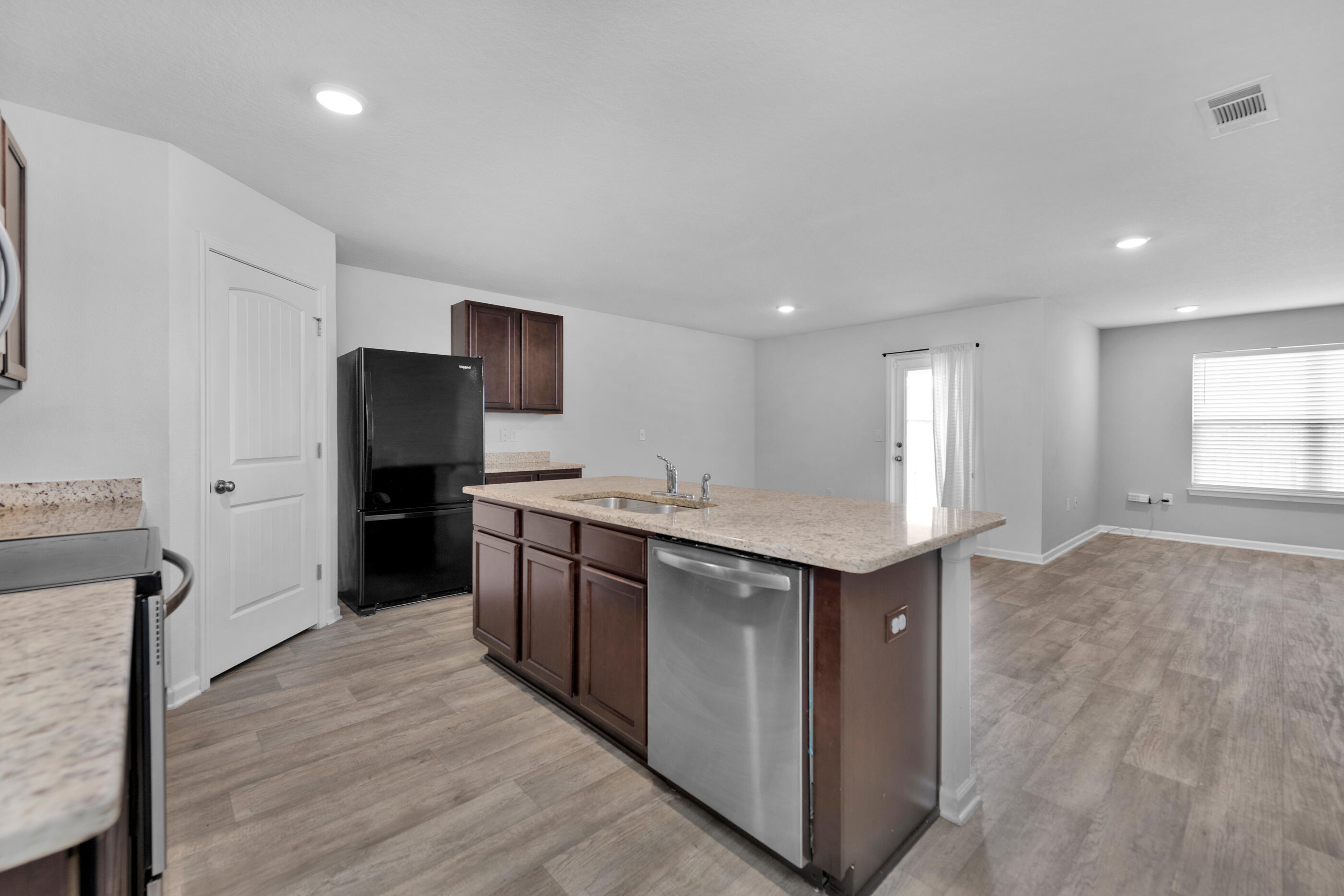 812 Moorhen Way Crestview, FL 32539 - Photo 4 of 22 a kitchen with stainless steel appliances granite countertop a stove and a refrigerator