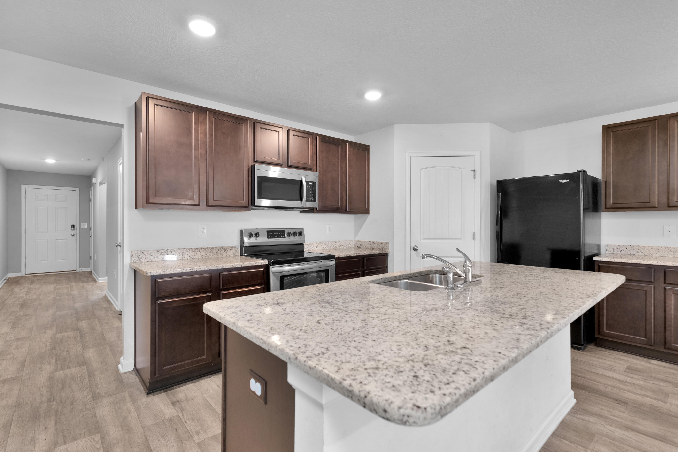 812 Moorhen Way Crestview, FL 32539 - Photo 5 of 22 a kitchen with stainless steel appliances granite countertop a refrigerator a stove a sink a microwave and cabinets