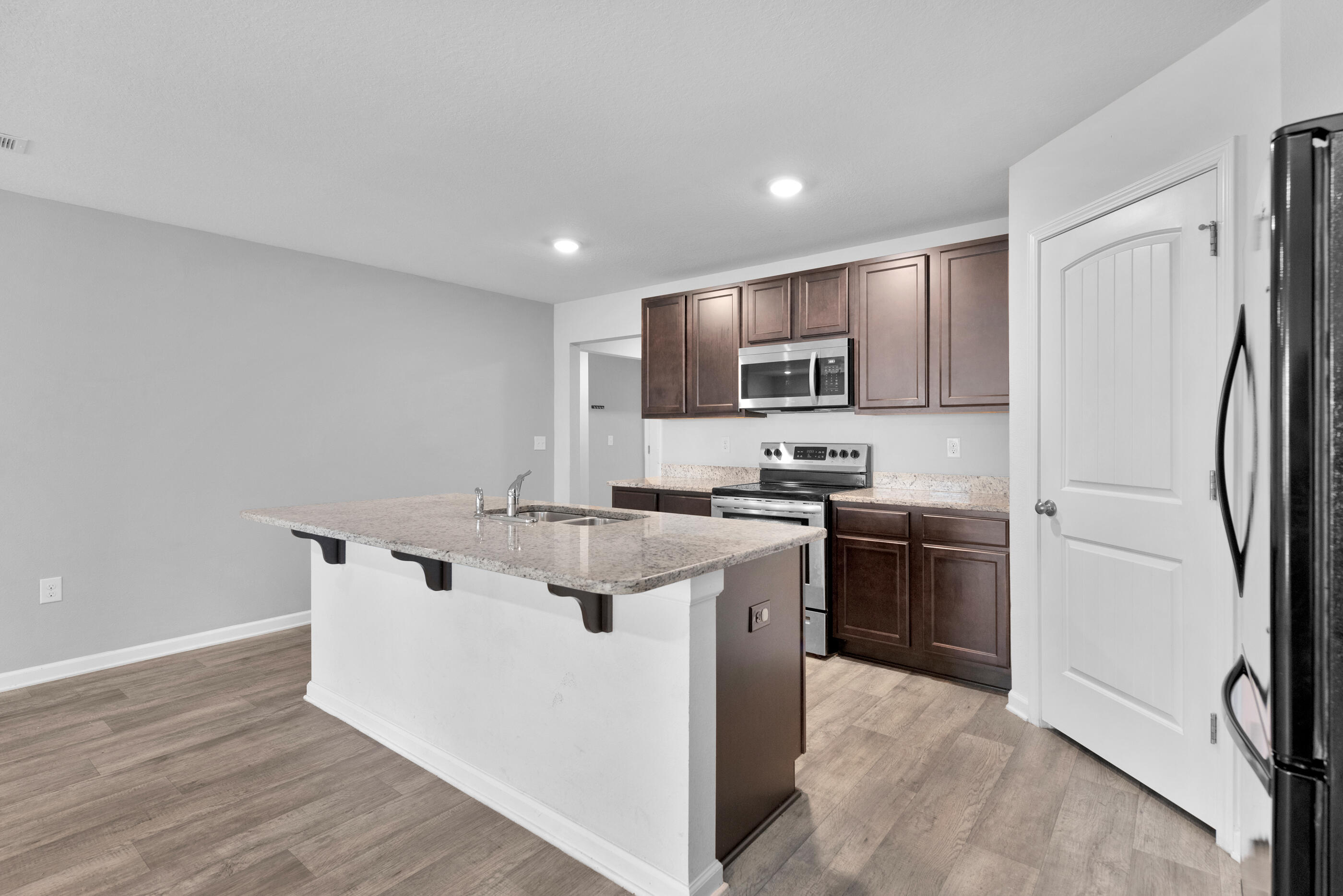 812 Moorhen Way Crestview, FL 32539 - Photo 6 of 22 a kitchen with stainless steel appliances granite countertop a refrigerator sink and stove