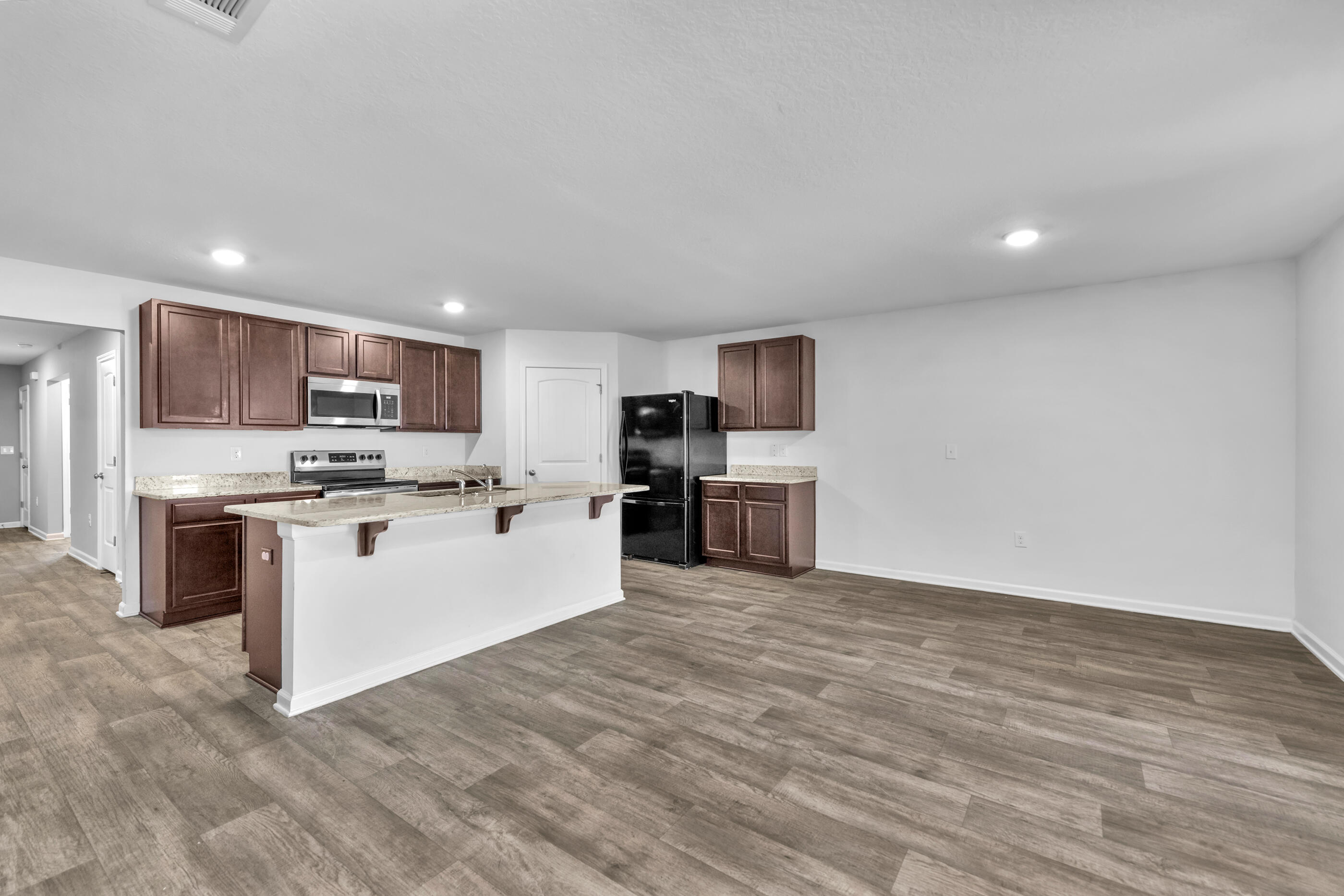 812 Moorhen Way Crestview, FL 32539 - Photo 8 of 22 a kitchen with a refrigerator and a microwave
