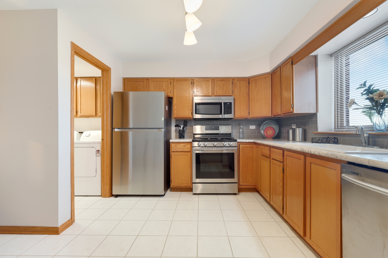 18206 Rita Road, Unit 2A Tinley Park, IL 60477 - Photo 8 of 22 a kitchen with stainless steel appliances granite countertop a refrigerator sink and stove