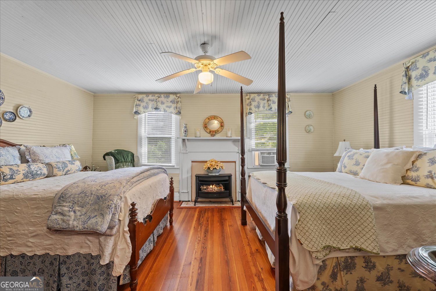 6644 East Cadley Road Norwood, GA 30821 - Photo 35 of 53 a bedroom with a bed and a chandelier