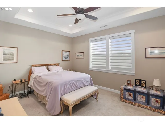 a bedroom with a bed a chandelier and a book shelf