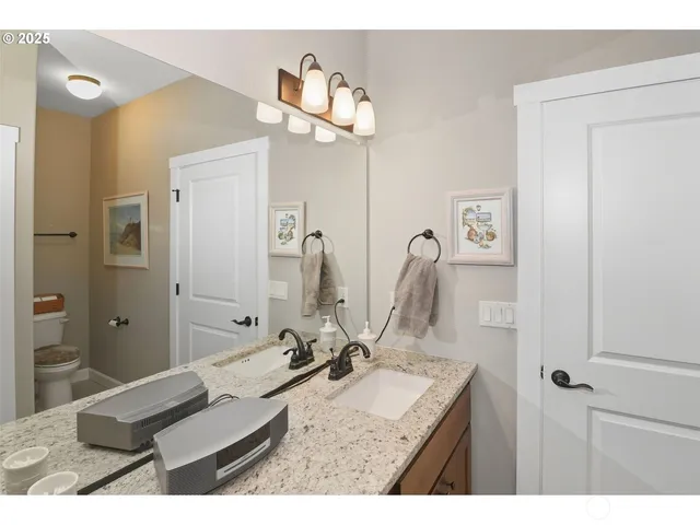 a bathroom with a sink vanity granite and a mirror