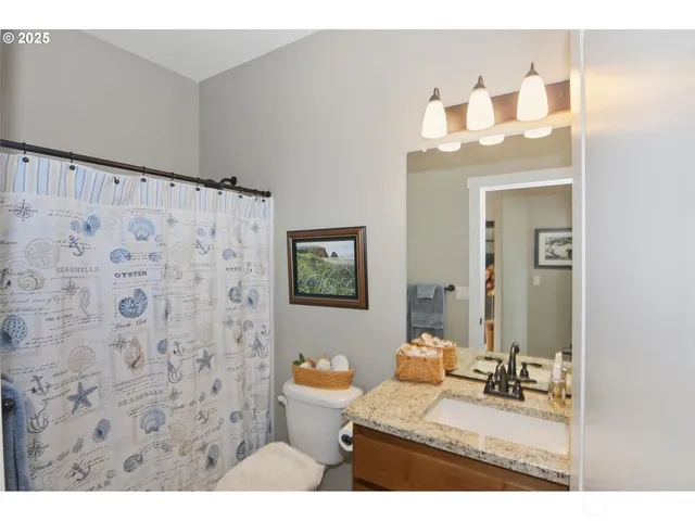 a bathroom with a sink mirror and vanity