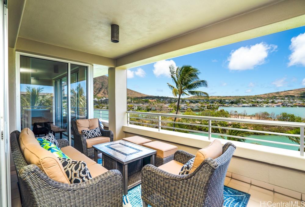 a balcony with couch and outdoor view