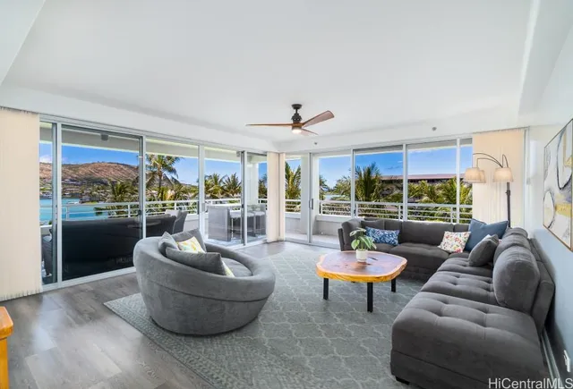 a living room with furniture and a potted plant