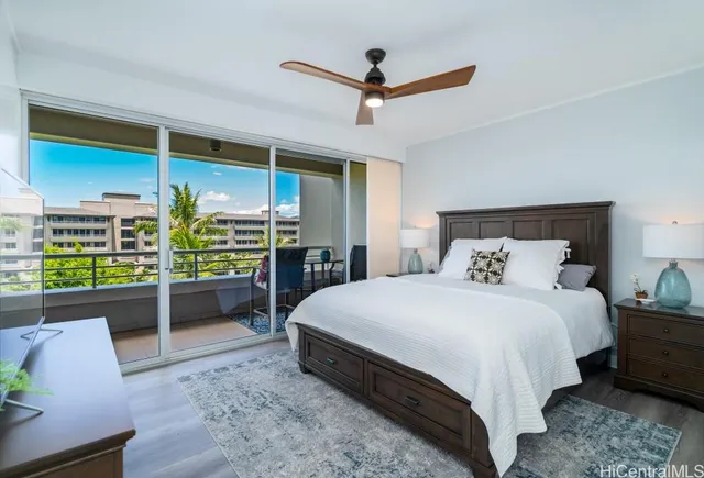 a bedroom with a bed and large window