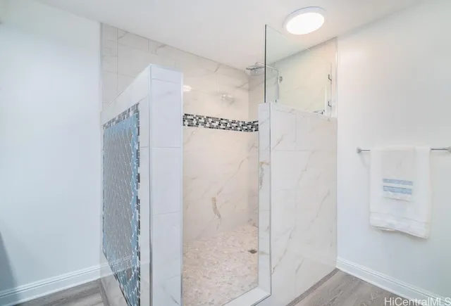 a bathroom with a shower and a glass door