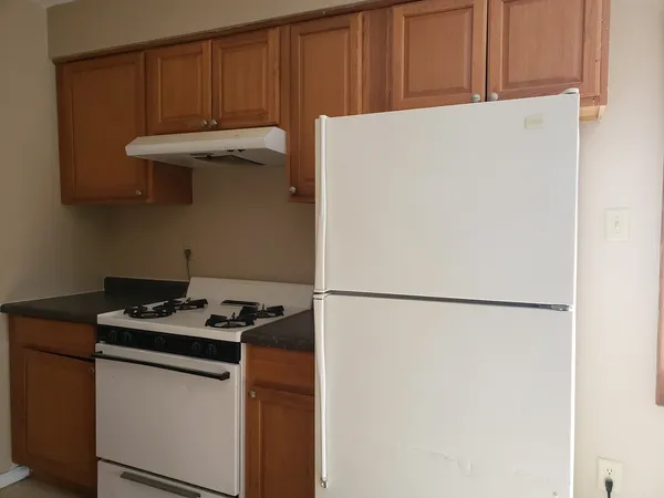 a white refrigerator freezer sitting inside of a kitchen