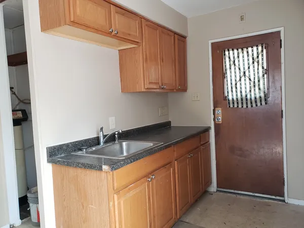 a kitchen with granite countertop cabinets and window