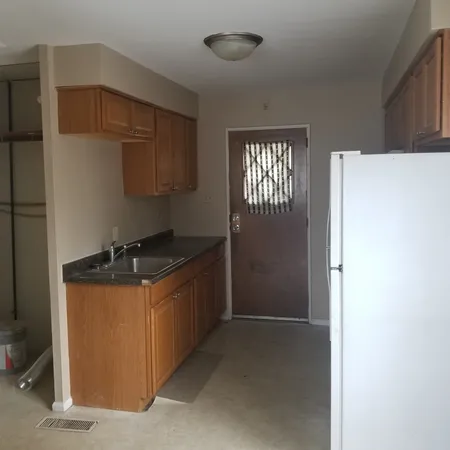 a kitchen with a stove and a refrigerator