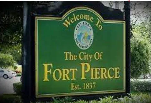 a sign broad in front of the tree