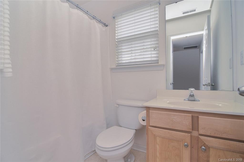 2117 Midnight Blue Lane Fort Mill, SC 29708 - Photo 22 of 26 a bathroom with a toilet sink vanity and mirror
