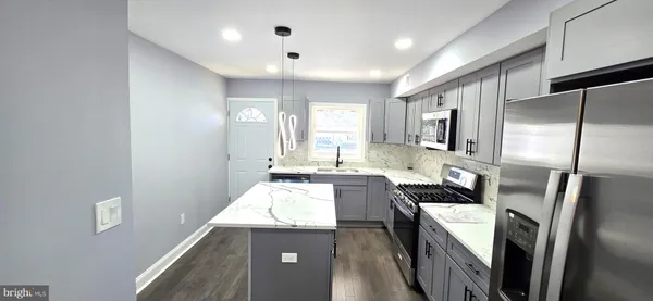 a kitchen with a refrigerator and a sink