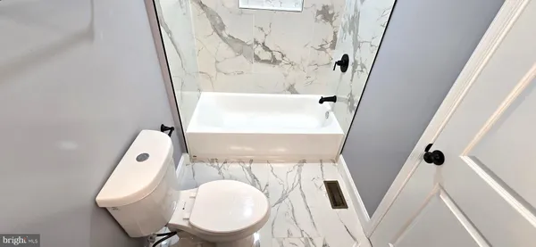 a bathroom with a toilet and a sink