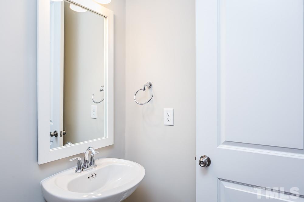 3247 Lynn Road, Unit 19 Raleigh, NC 27613 - Photo 12 of 20 a bathroom with a sink a mirror and shower