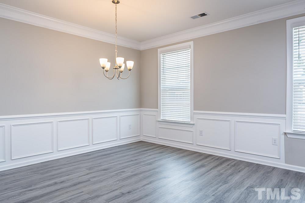 3247 Lynn Road, Unit 19 Raleigh, NC 27613 - Photo 13 of 20 an empty room with wooden floor and windows