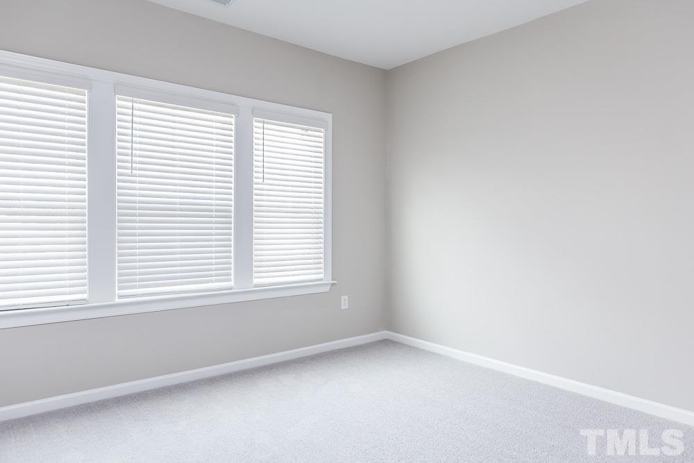 3247 Lynn Road, Unit 19 Raleigh, NC 27613 - Photo 17 of 20 an empty room with a window
