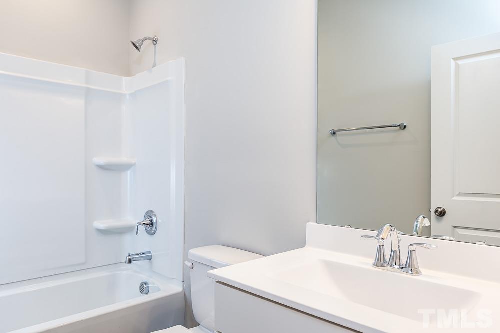 3247 Lynn Road, Unit 19 Raleigh, NC 27613 - Photo 19 of 20 a bathroom with a sink a toilet and shower