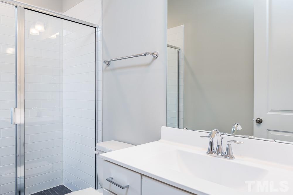 3247 Lynn Road, Unit 19 Raleigh, NC 27613 - Photo 10 of 20 a bathroom with a sink and a mirror