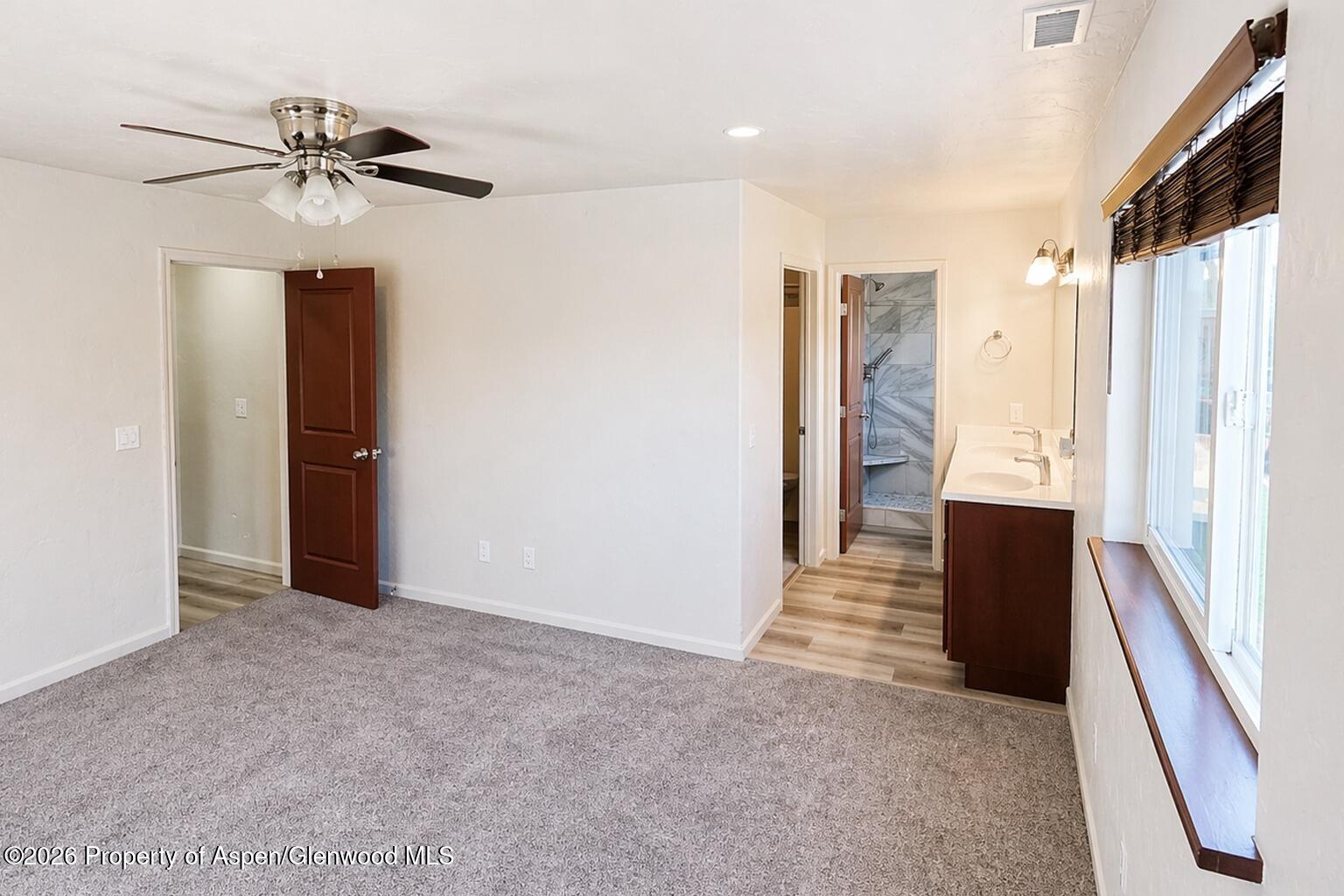 1648 Arabian Avenue Rifle, CO 81650 - Photo 9 of 15 a view of hallway with stairs and a chandelier