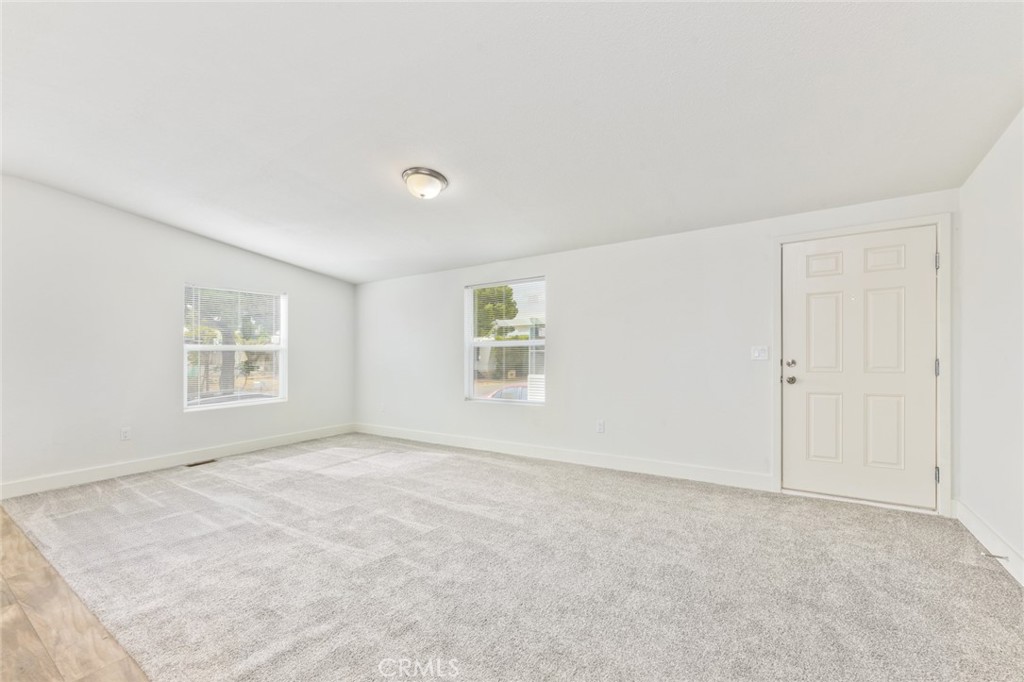 15252 Seneca Road, Unit 167 Victorville, CA 92392 - Photo 2 of 7 an empty room with a empty space and windows