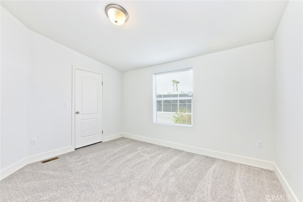 15252 Seneca Road, Unit 167 Victorville, CA 92392 - Photo 7 of 7 an empty room with windows