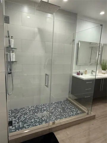 a bathroom with a sink double vanity and a mirror