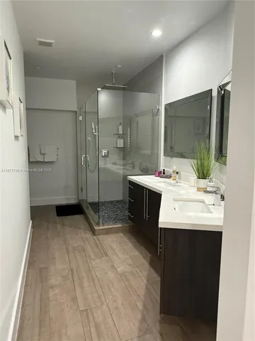 a large bed sitting in a bedroom next to a window