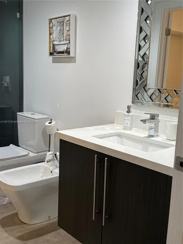 a bathroom with a toilet a sink and a shower