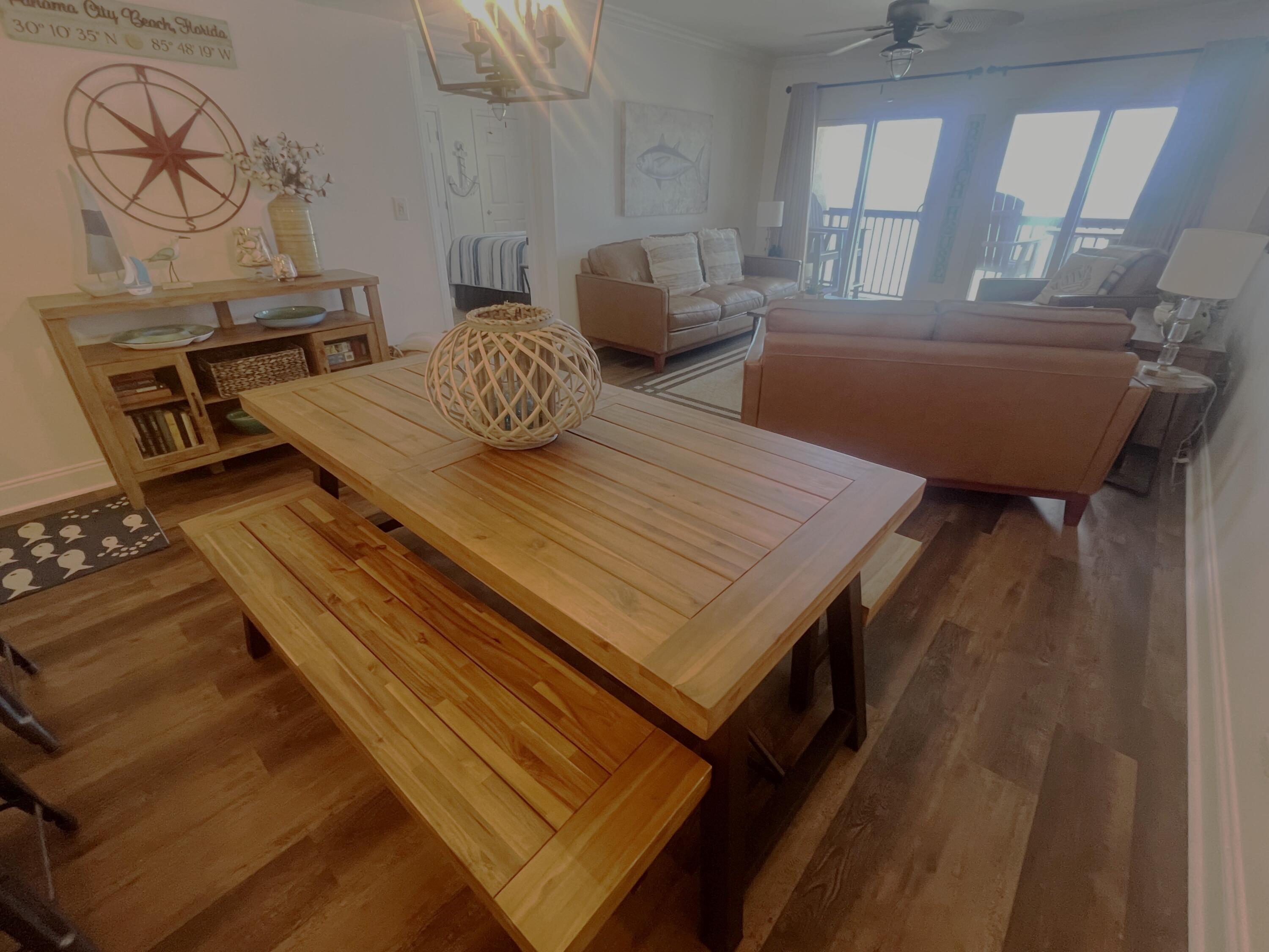 23223 Front Beach Road, Unit 703 Panama City Beach, FL 32413 - Photo 16 of 34 a living room with furniture and a table