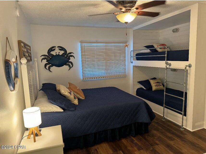 23223 Front Beach Road, Unit 703 Panama City Beach, FL 32413 - Photo 19 of 34 a bedroom with a bed and a chandelier