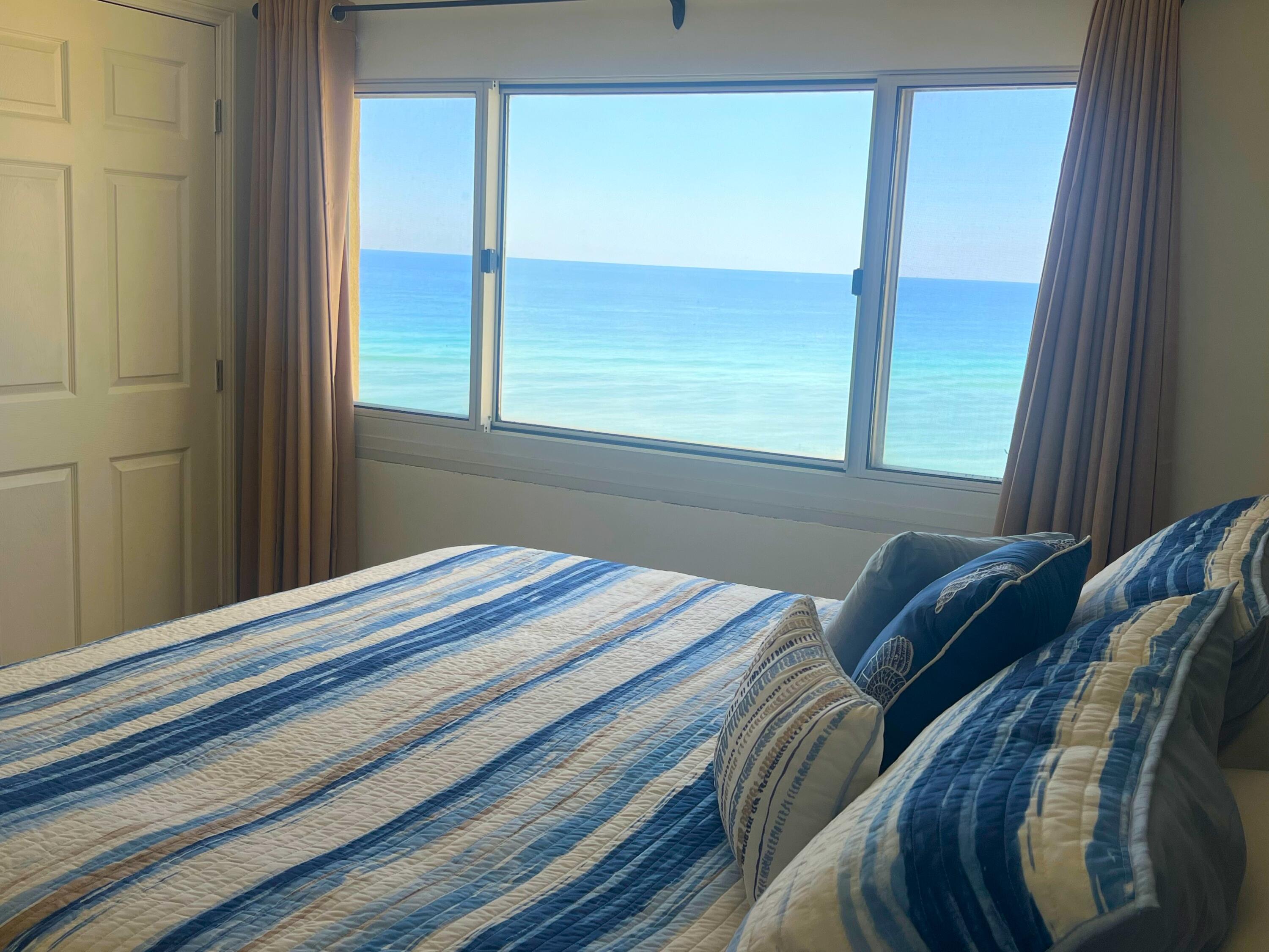 23223 Front Beach Road, Unit 703 Panama City Beach, FL 32413 - Photo 22 of 34 a bedroom with a bed and a window