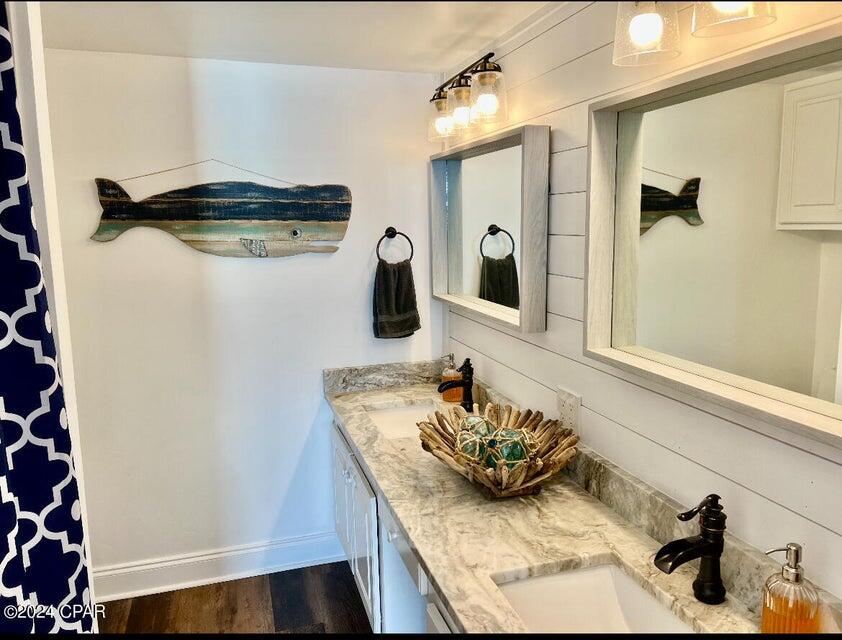 23223 Front Beach Road, Unit 703 Panama City Beach, FL 32413 - Photo 23 of 34 a bathroom with a sink and a mirror