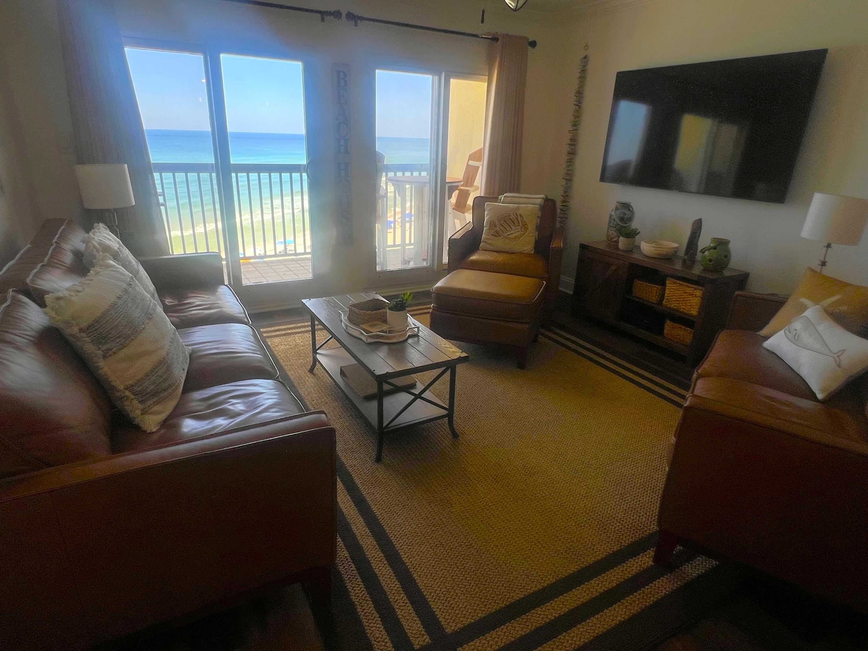 23223 Front Beach Road, Unit 703 Panama City Beach, FL 32413 - Photo 3 of 34 a living room with furniture and a flat screen tv