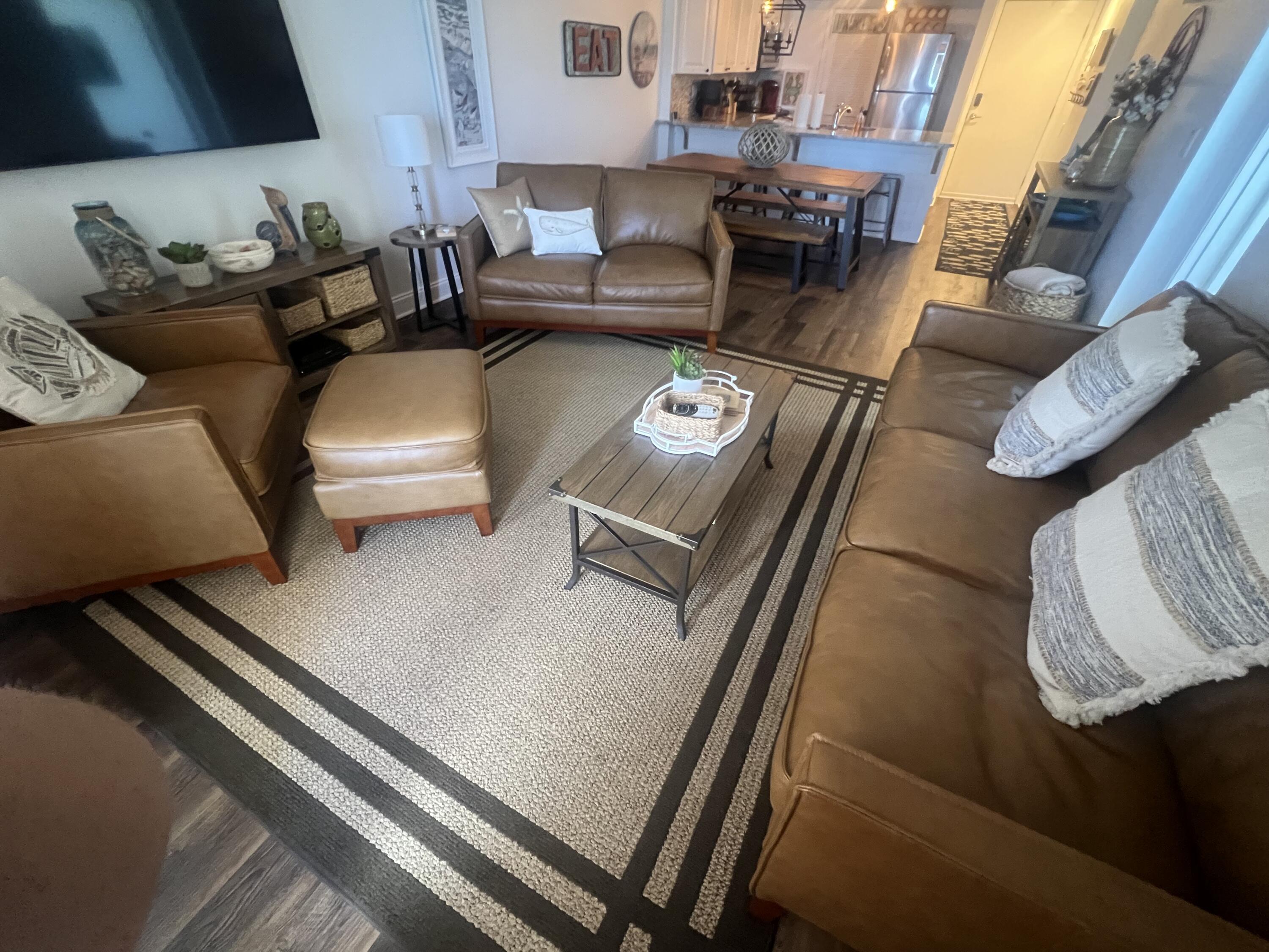 23223 Front Beach Road, Unit 703 Panama City Beach, FL 32413 - Photo 8 of 34 a living room with furniture and a couch