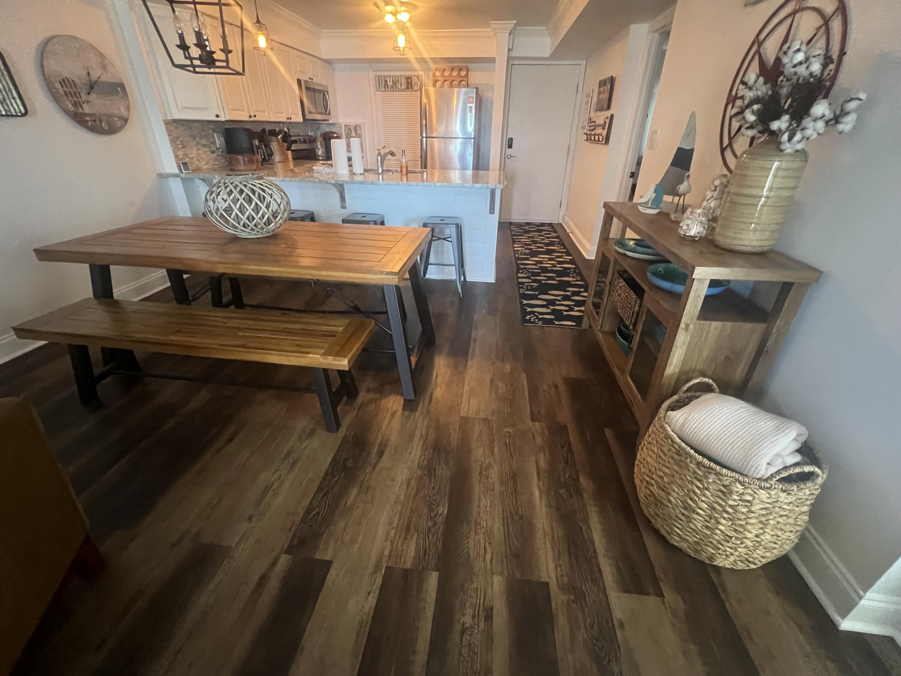 23223 Front Beach Road, Unit 703 Panama City Beach, FL 32413 - Photo 10 of 34 a living room with furniture and a wooden floor