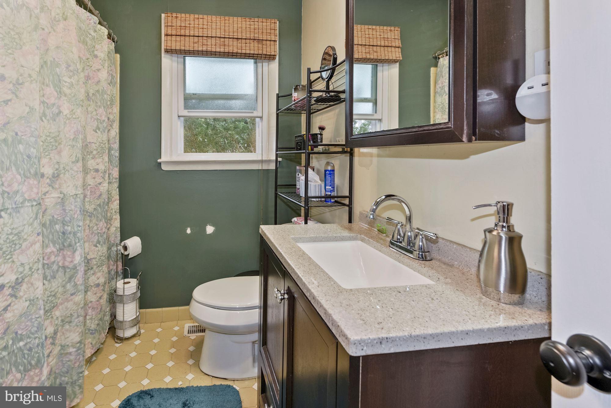 374 Holly Road Marlton, NJ 08053 - Photo 15 of 28 a bathroom with a granite countertop sink a toilet and a mirror