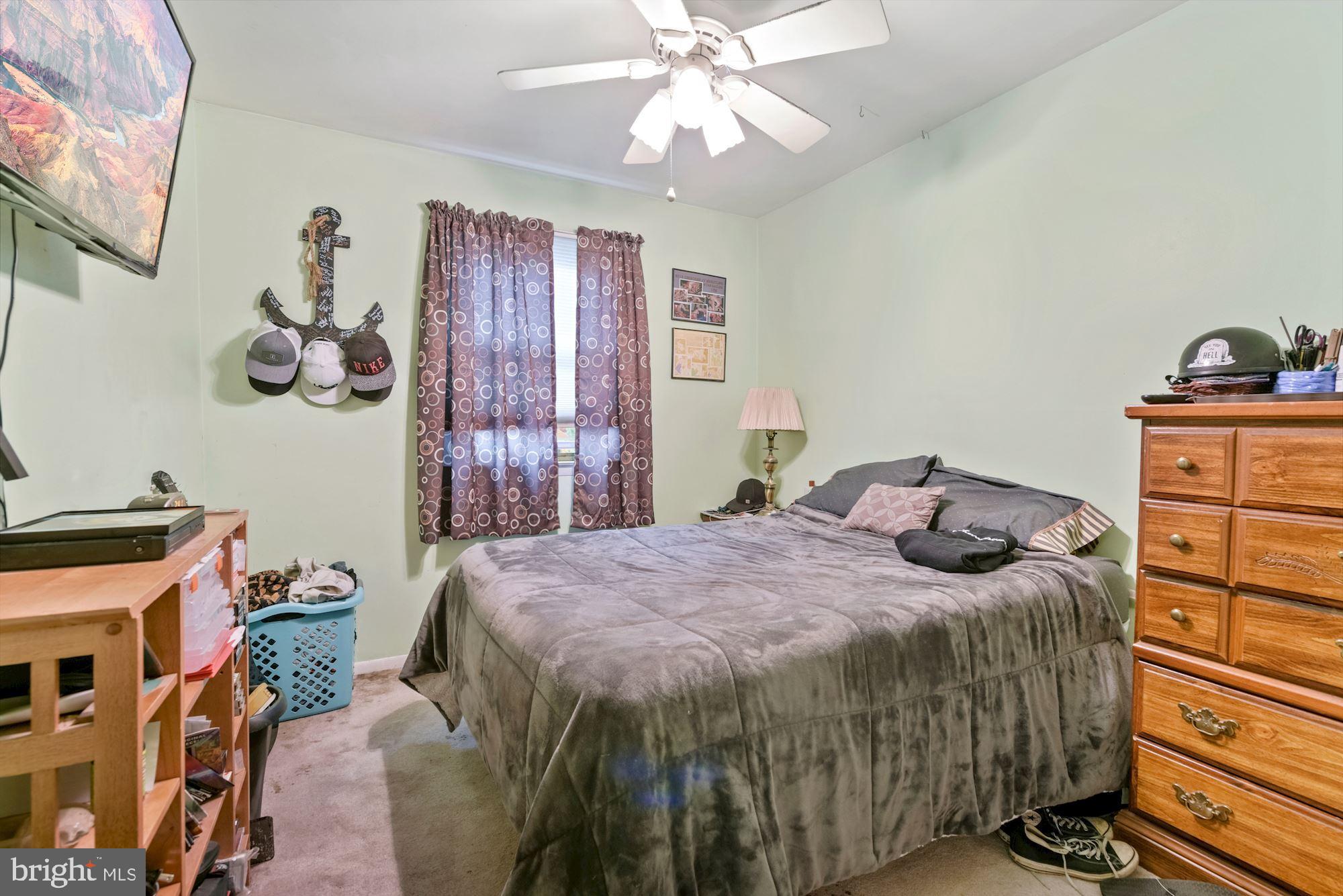 374 Holly Road Marlton, NJ 08053 - Photo 16 of 28 a bedroom with a bed and wooden floor