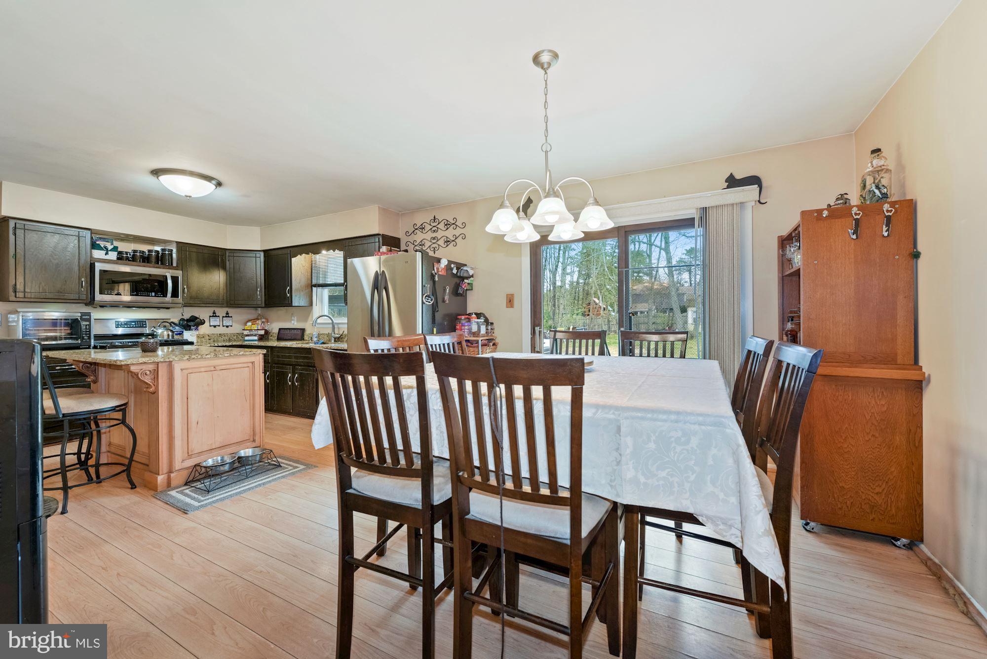 374 Holly Road Marlton, NJ 08053 - Photo 5 of 28 a dining room with furniture a chandelier and wooden floor
