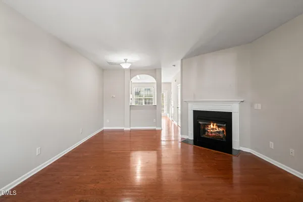 a view of an empty room with a fireplace