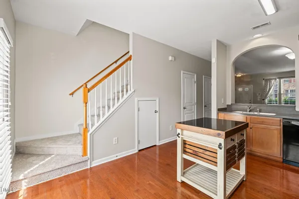 a view of a livingroom with furniture hardwood floor and staircase