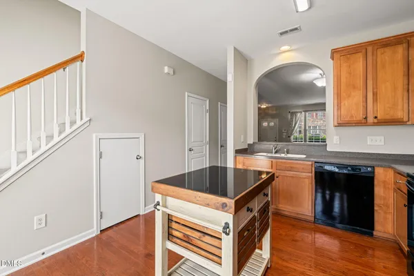 a kitchen that has a sink and a stove in it