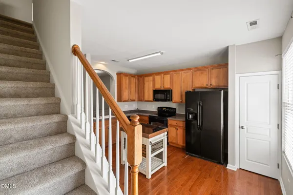 a view of a kitchen with cabinets and stainless steel appliances