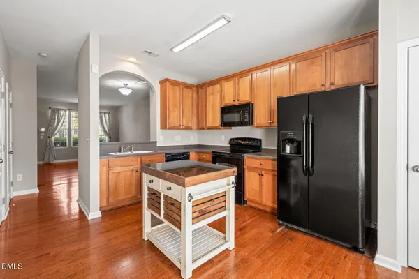 a kitchen with stainless steel appliances a refrigerator and a stove top oven