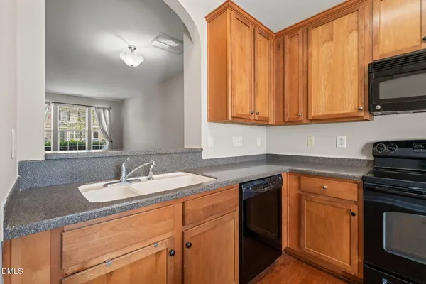 a kitchen with a sink stove and microwave