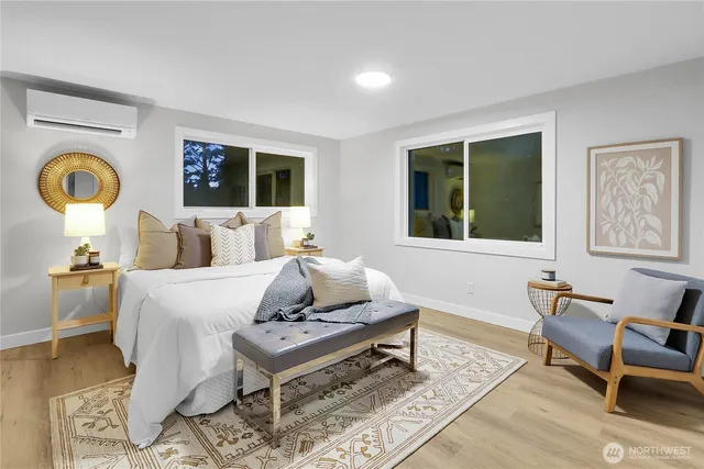 a bedroom with a bed and wooden floor